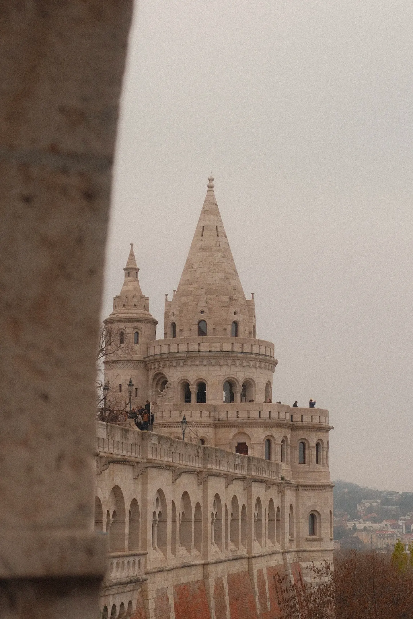 A spire of Fisherman's Bastion in Budapest on a grey day