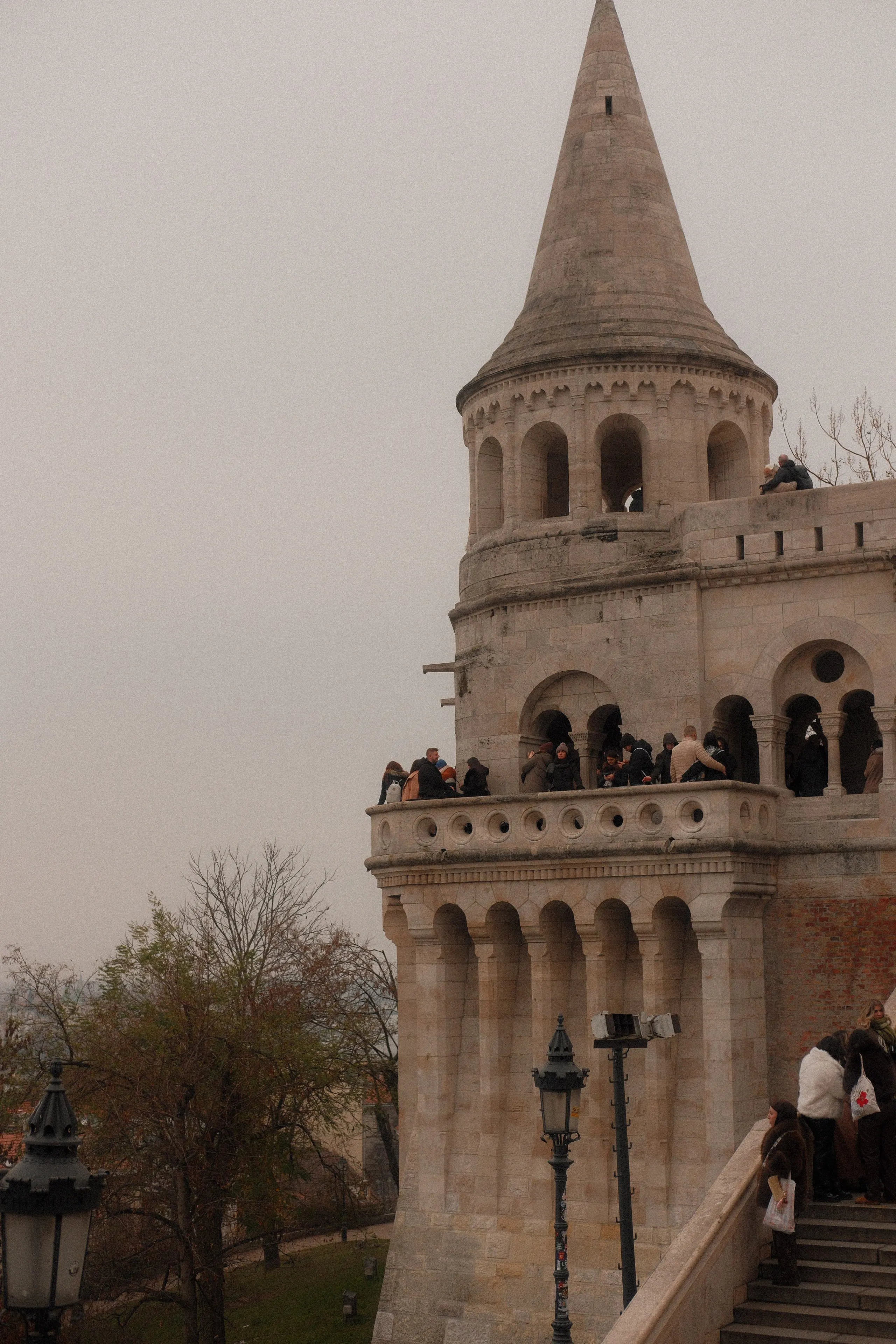 A conical tower of Fisherman's Bastion with people on its balcony
