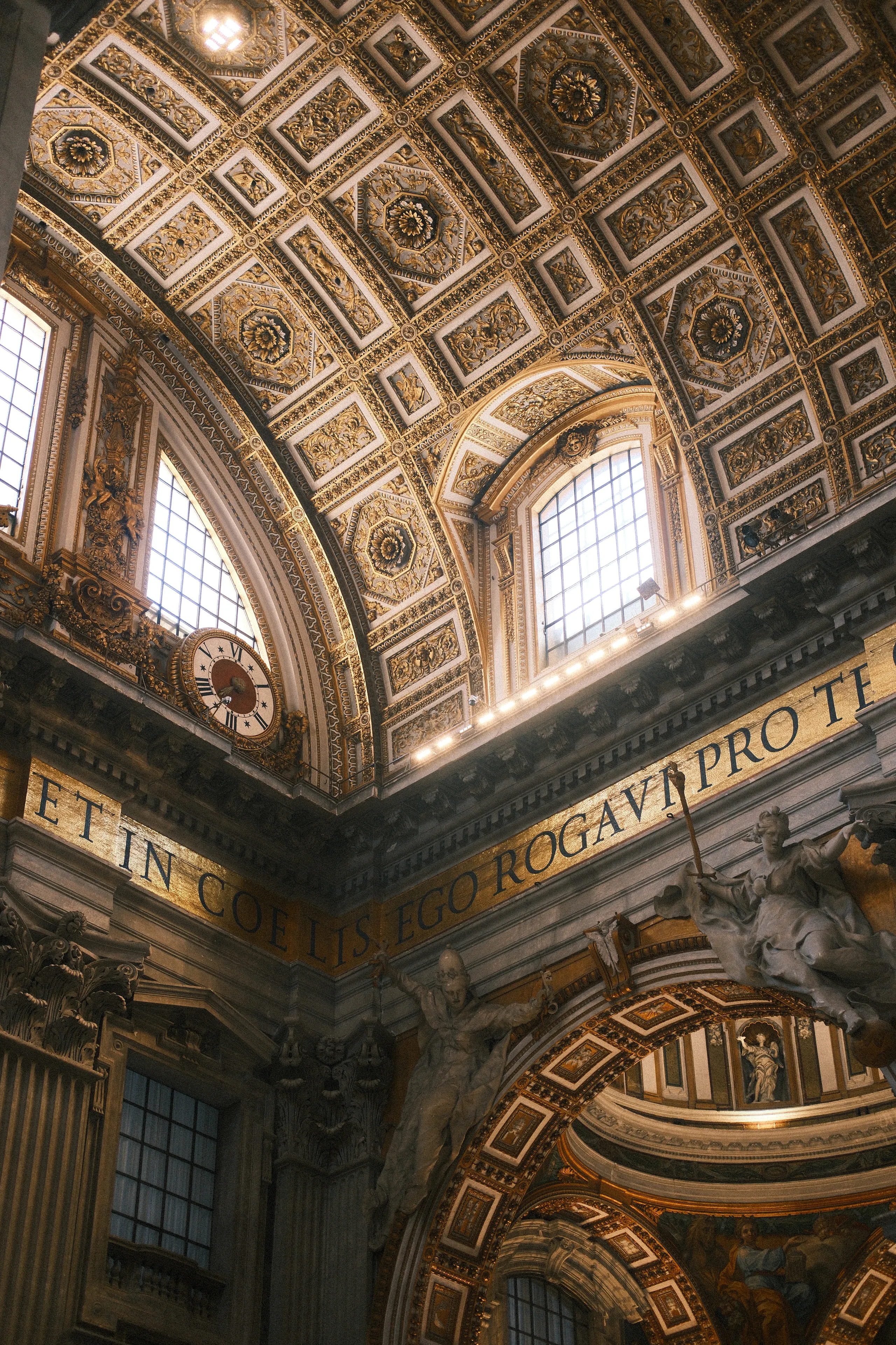 The gilded coffered ceiling and windows inside St. Peter's Basilica