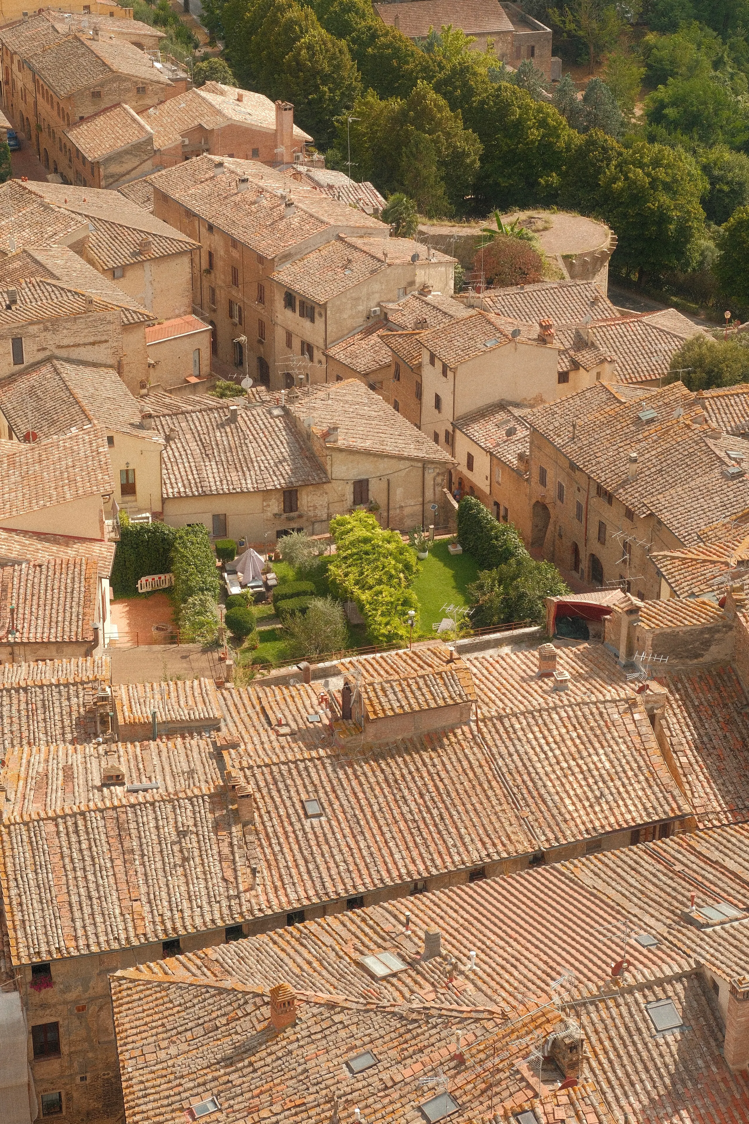 Terracotta rooftops of a Tuscan hill town from above