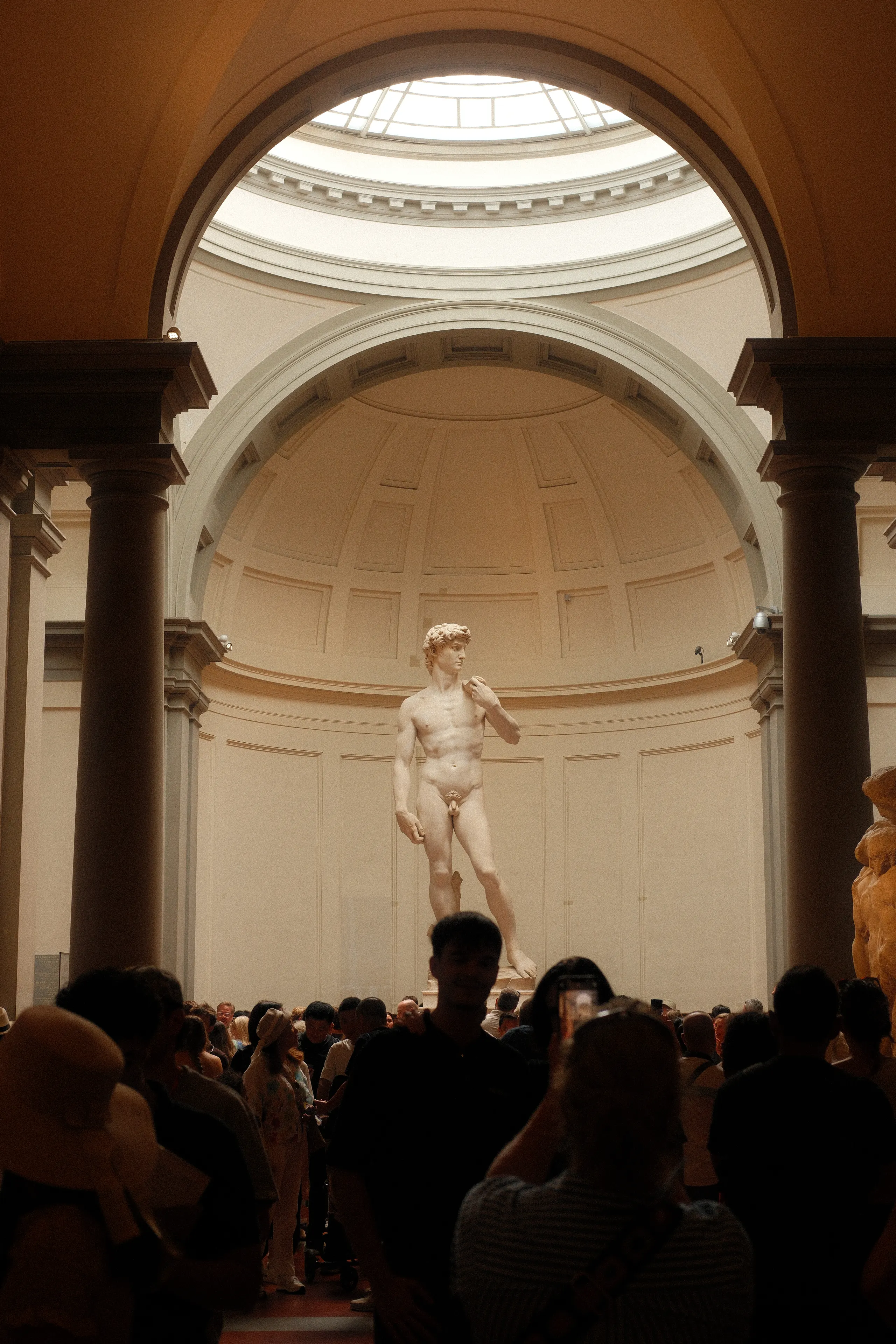 Michelangelo's David under the dome of the Accademia, a crowd in front