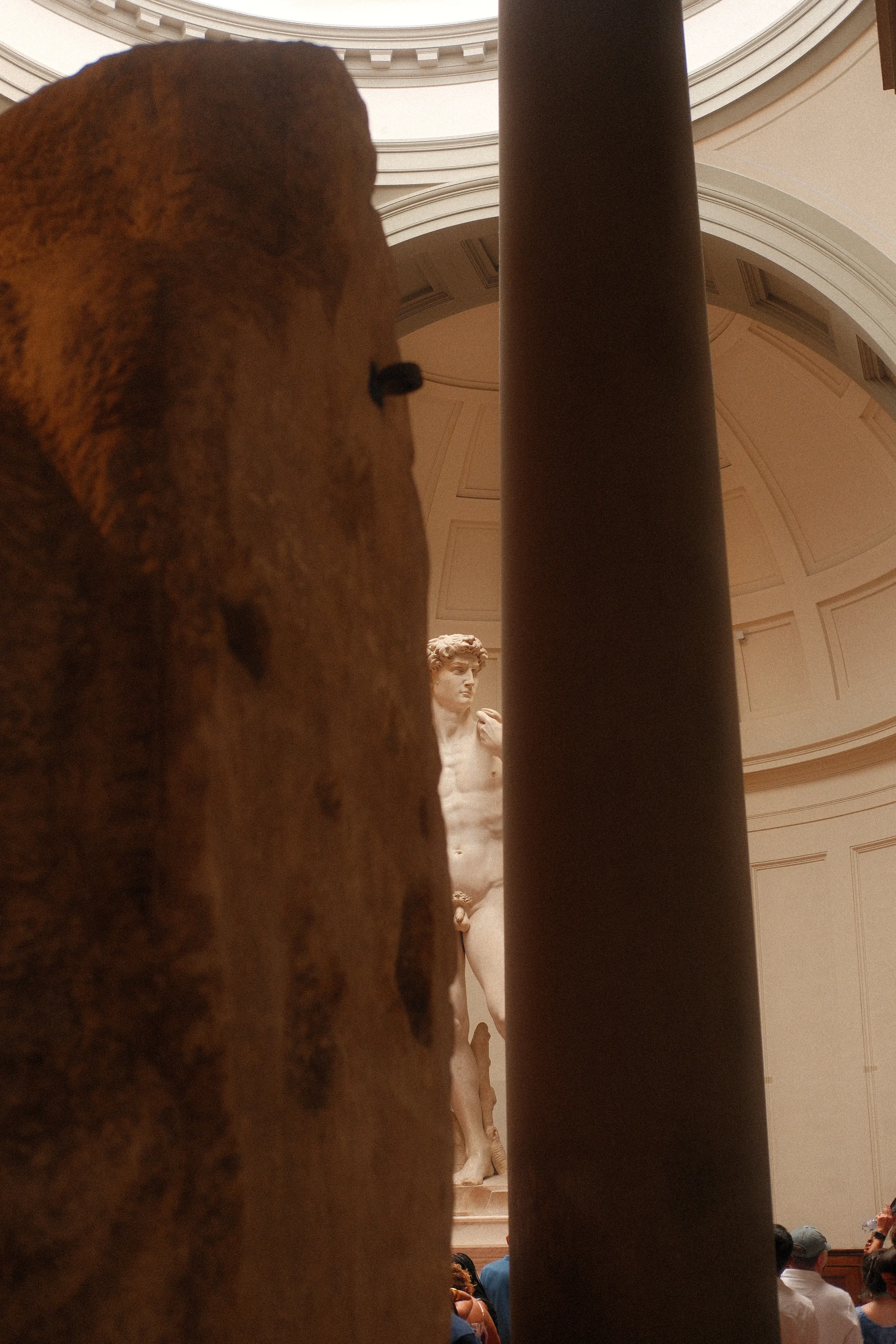 David glimpsed between a stone block and a column in the Accademia