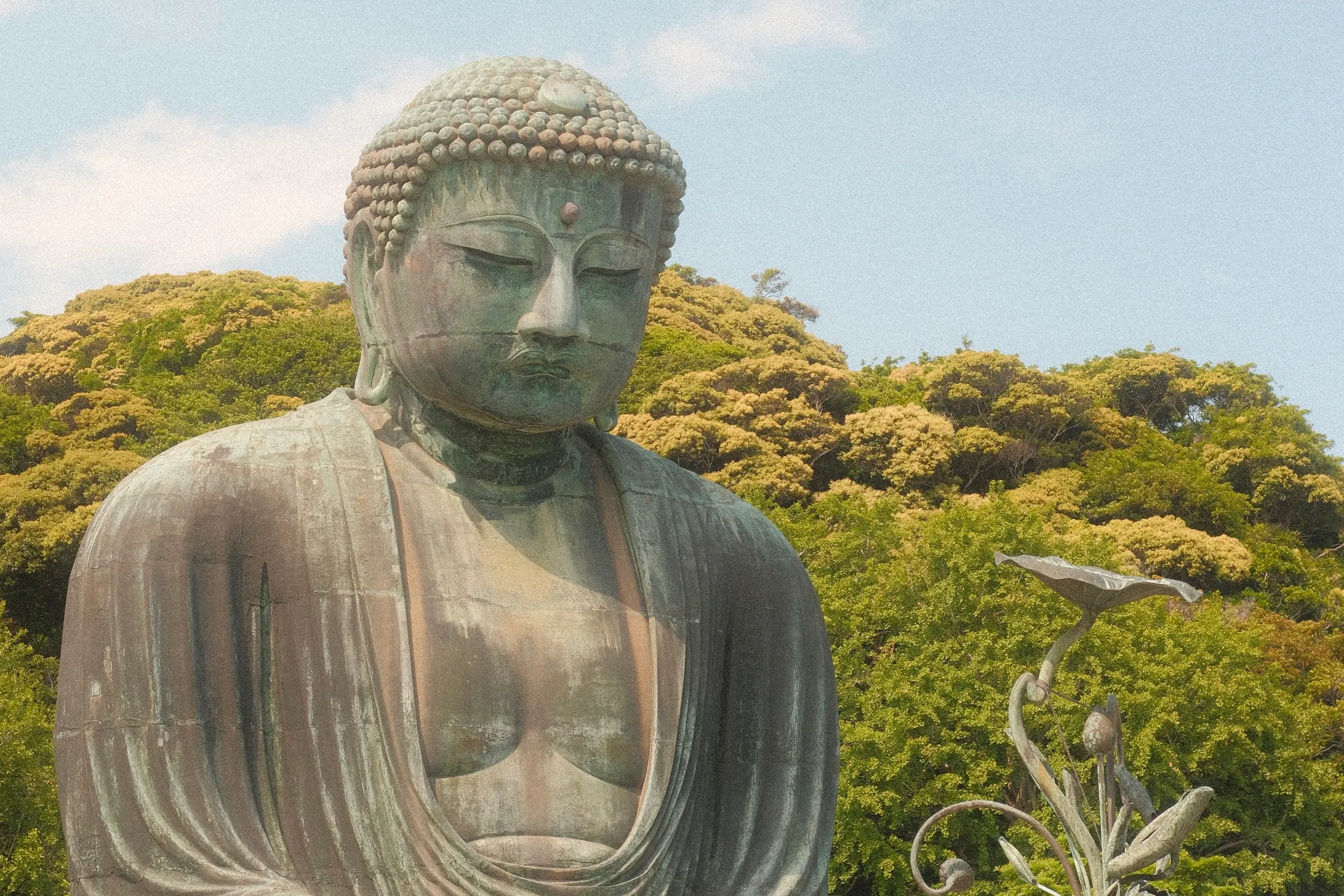 The Great Buddha of Kamakura against green hills