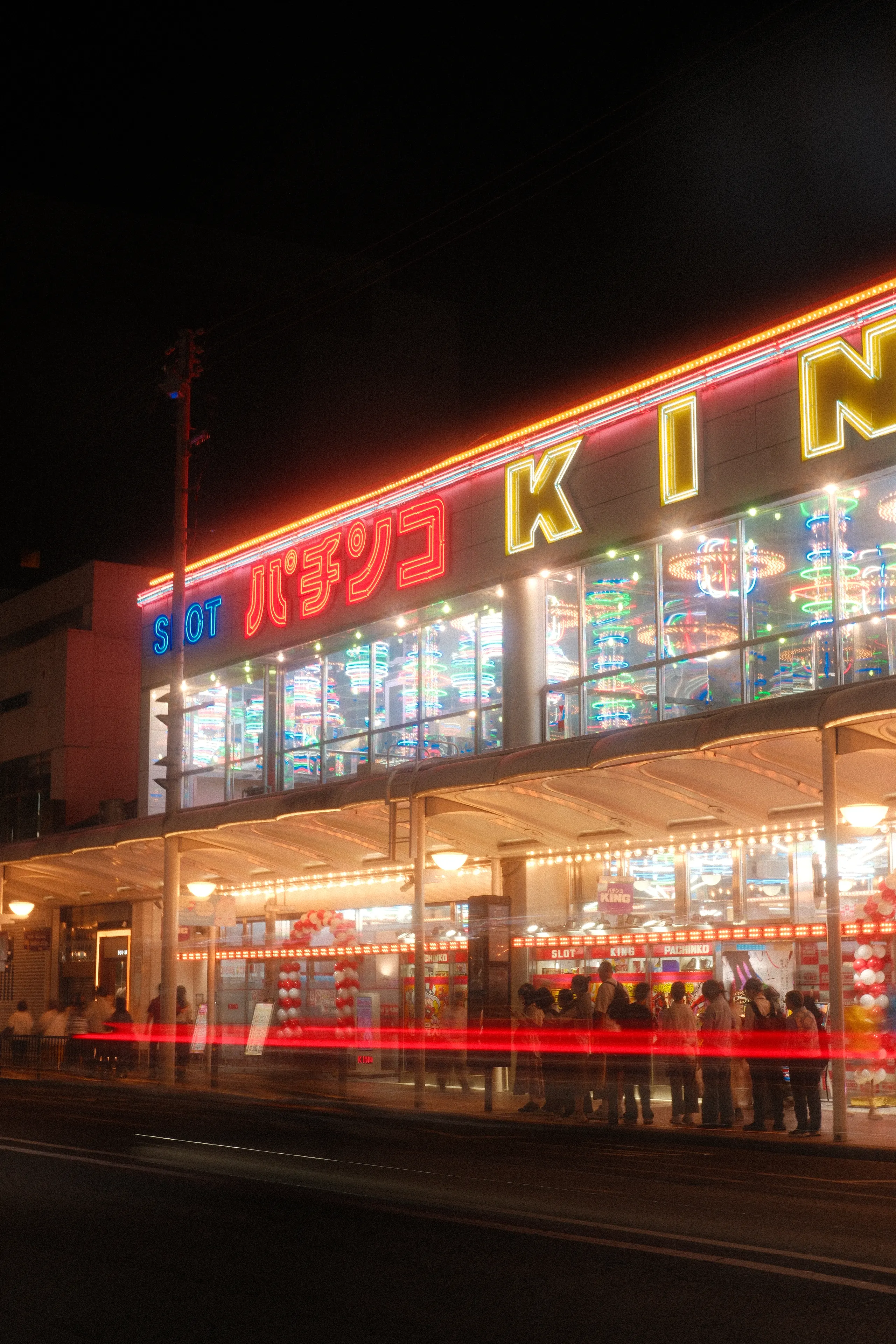 A pachinko parlor lit up in neon at night