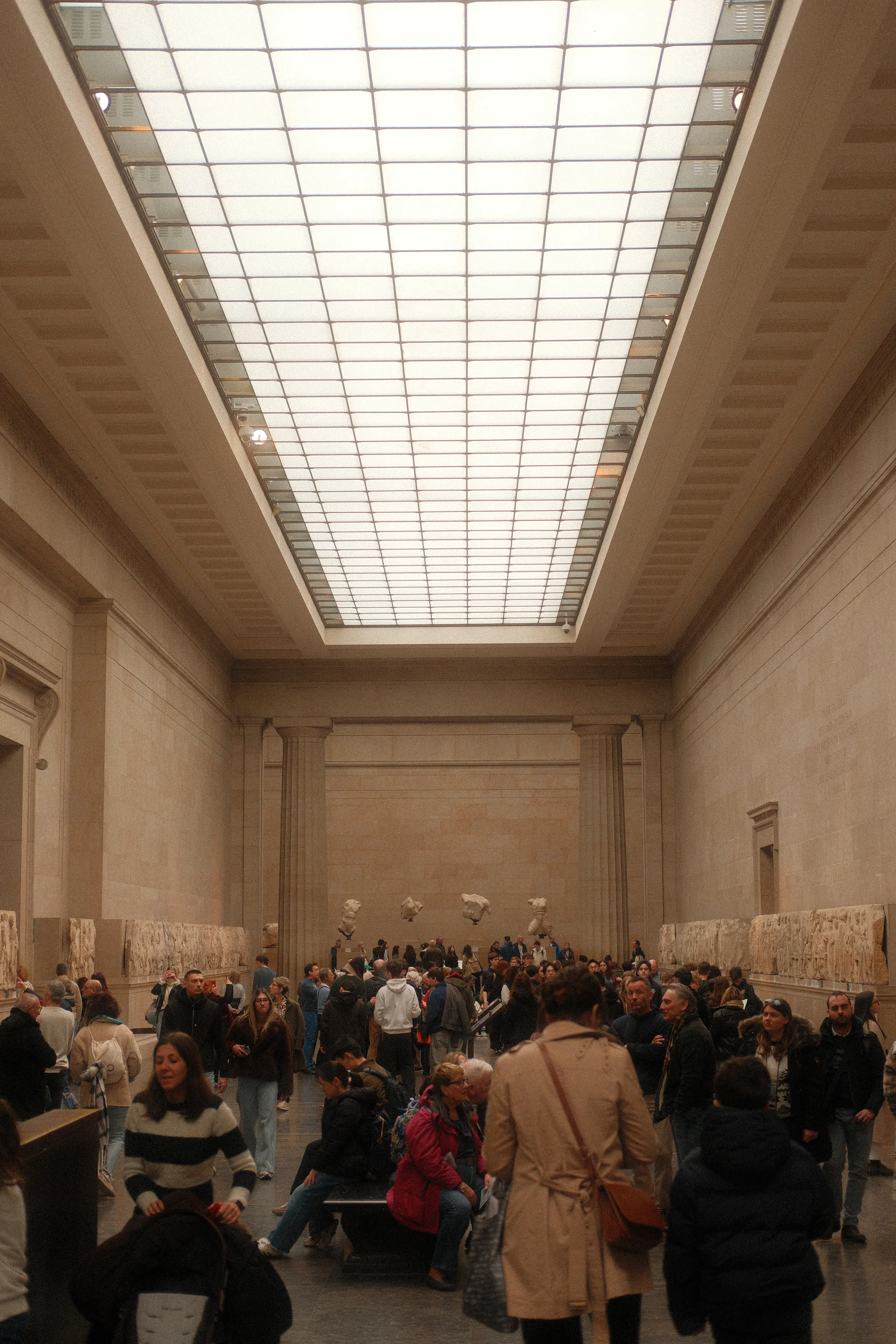 A skylit gallery in the British Museum full of visitors