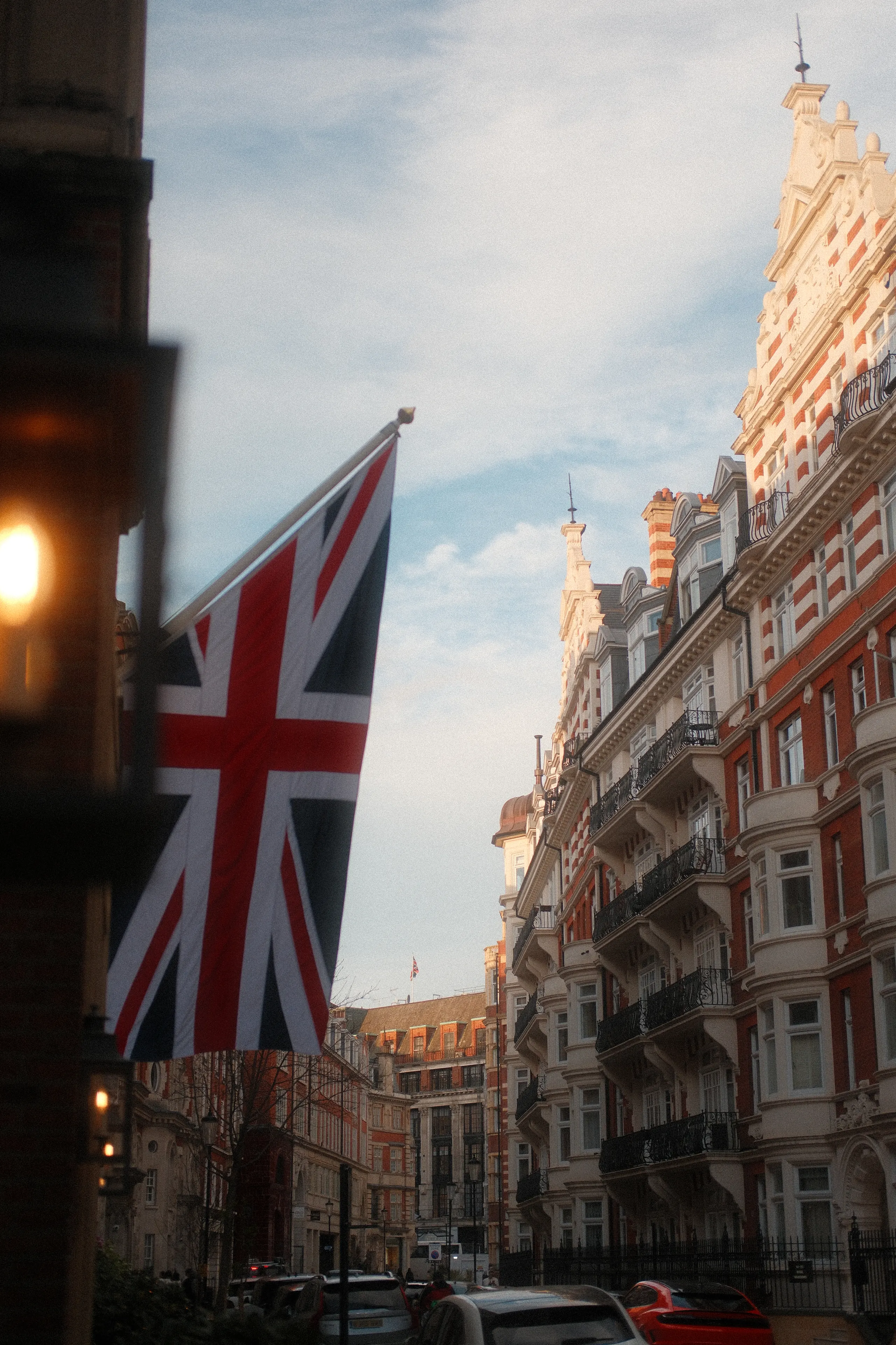 A Union Jack and a street lamp against Victorian facades