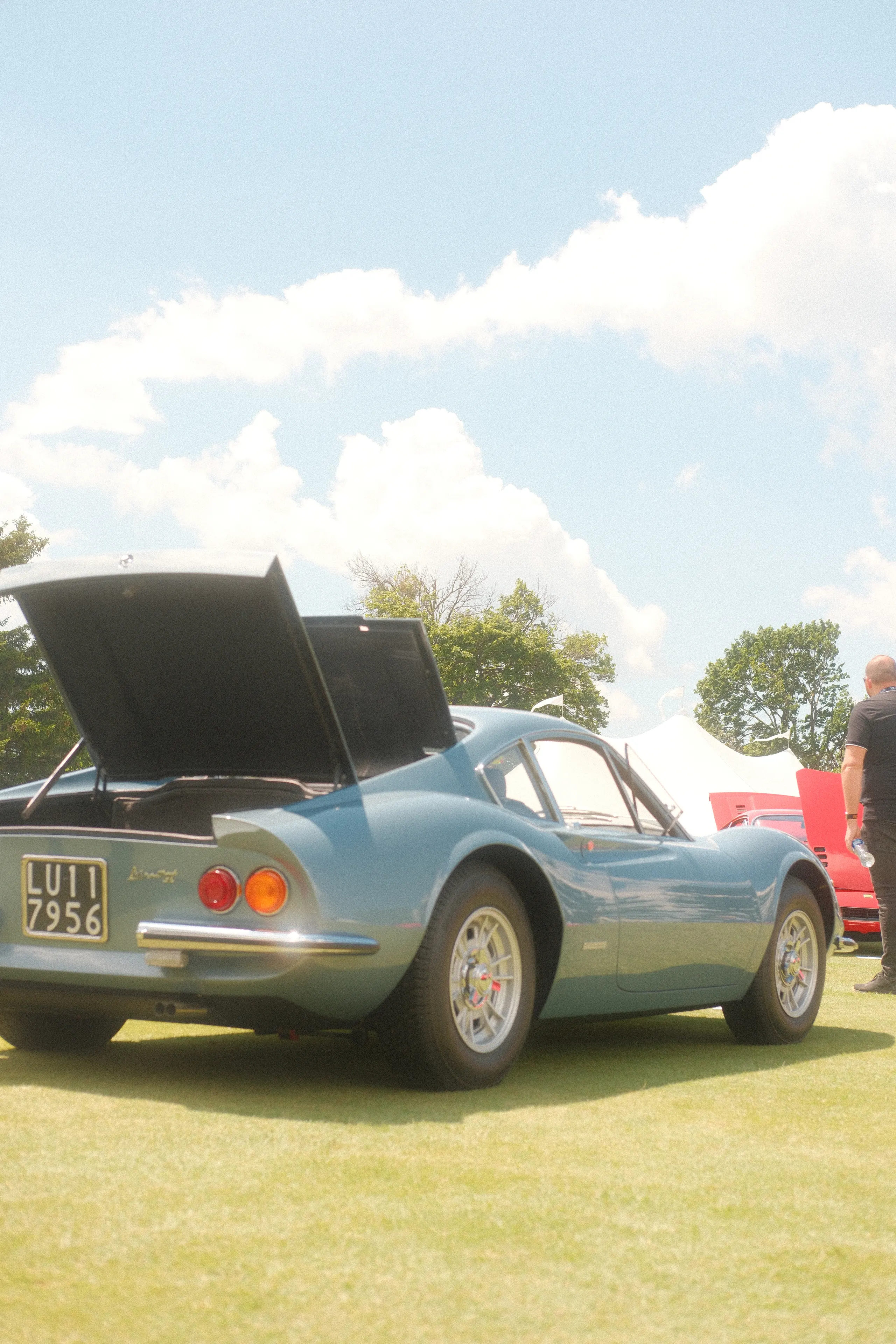 A blue Ferrari Dino with its rear deck open