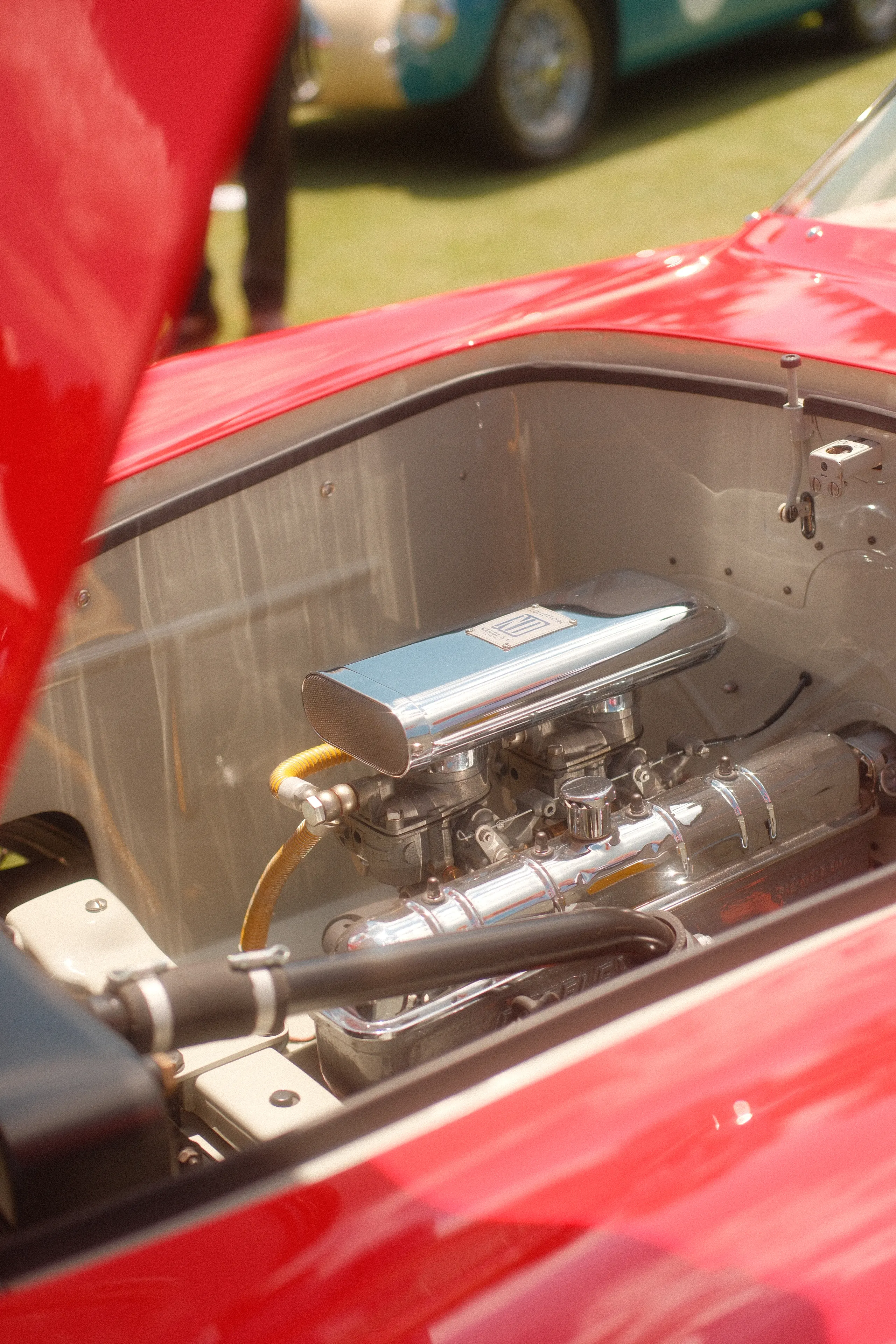 The polished engine bay of a red race car