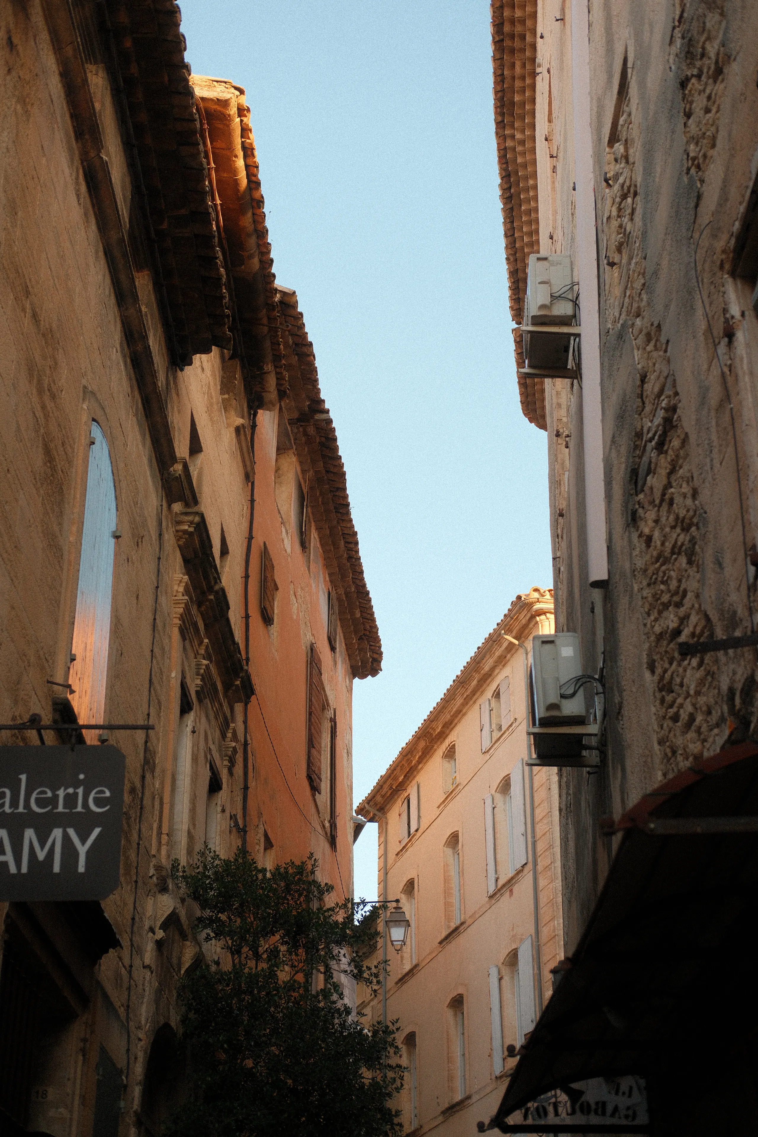 A narrow stone street in Gordes under a blue sky